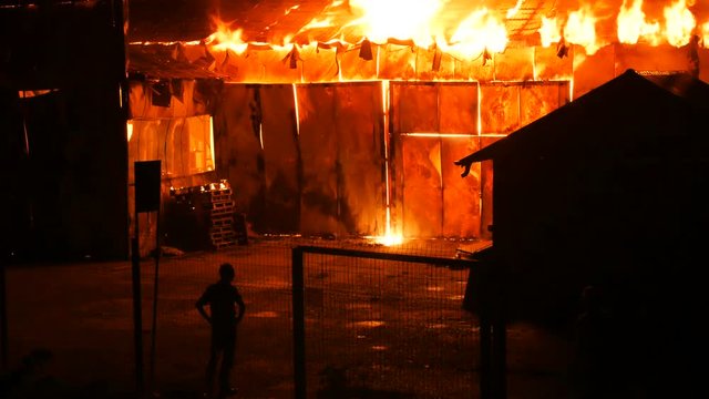 Man Watching His House Burn Down