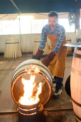 wood barrels production cooper using hammer and tools in workshop © auremar