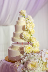 White wedding cake with flowers and blueberries