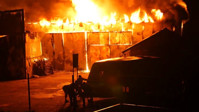 People Saving A Caravan From A Fire