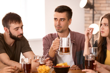 Friends drinking beer in bar