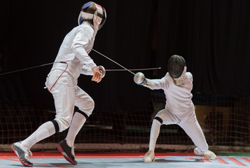 Two man fencing athletes fight