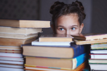 girl with piles of books