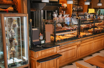 Interior of shop with fresh bakery on counter - obrazy, fototapety, plakaty