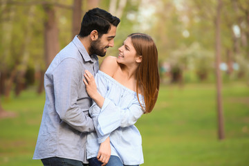 Happy young couple in park on spring day