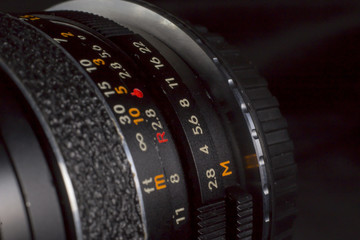 DSLR vintage wide lens close up with focus ring measures. Precise photography concept.