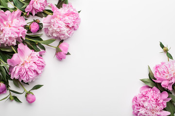 Flowers composition. Frame made of pink peony flowers on white background. Flat lay, top view.