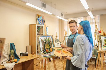 Art students painting in workshop