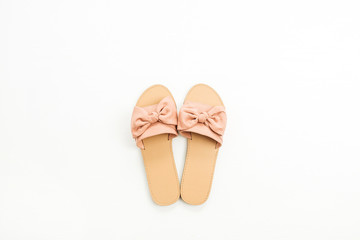 Pink female slippers on white background. Flat lay, top view. Summer fashion concept.