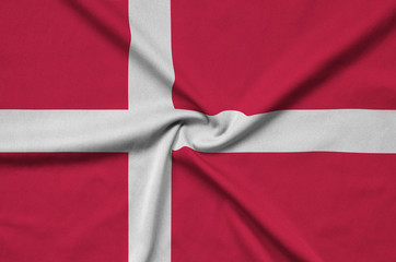 Denmark flag  is depicted on a sports cloth fabric with many folds. Sport team banner