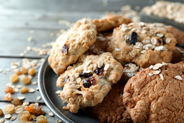 Plate with delicious oatmeal cookies on wooden table