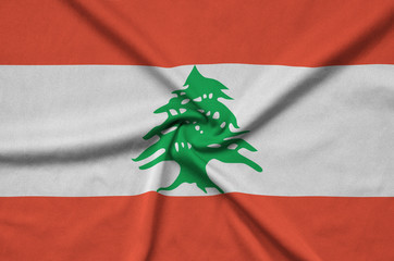 Lebanon flag  is depicted on a sports cloth fabric with many folds. Sport team banner