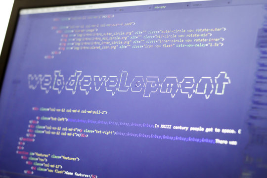 Web development phrase ASCII art inside real HTML code. Web developing concept on screen. Abstract information technology modern background. Digital art. Code is created by myself.