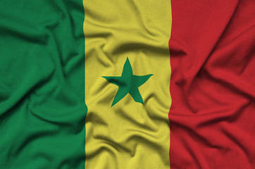 Senegal flag  is depicted on a sports cloth fabric with many folds. Sport team banner