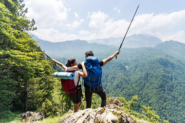 Couple backpackers enjoying mountains view