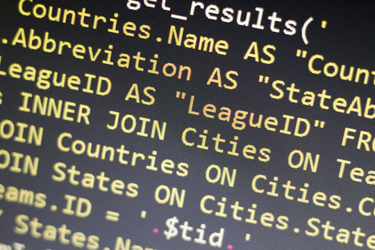 Web developer PHP code close up. Macro shot of complicated SQL query to database. Abstract information technology modern background. Concept screen of experienced software developer.