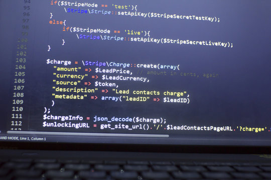 Web developer PHP code close up. Charging customer using Stripe API. Online payments processing. Abstract information technonology modern background. Concept screen of web developer.
