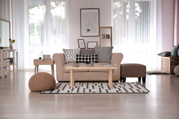 Stylish interior of living room with sofa and table