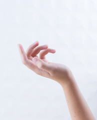 Closeup image of beautiful woman's hands with natural manicure in a beautiful pose. Cream for hands, manicure and beauty treatment. Elegant and graceful hands with slender graceful fingers.