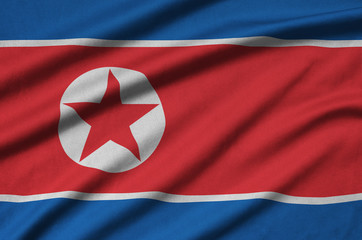 North Korea flag  is depicted on a sports cloth fabric with many folds. Sport team banner