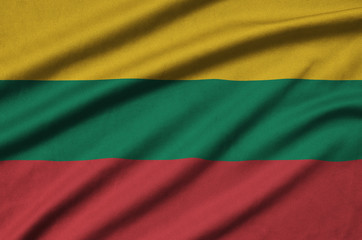 Lithuania flag  is depicted on a sports cloth fabric with many folds. Sport team banner