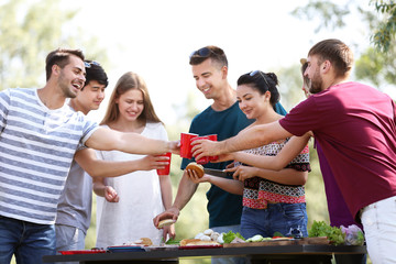 Young people having barbecue party in park