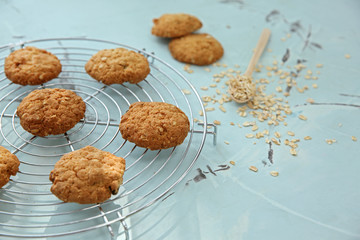 Cooling rack with delicious oatmeal cookies on table