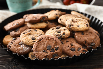 Delicious cookies with chocolate chips on table