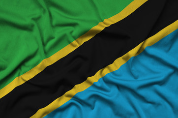 Tanzania flag  is depicted on a sports cloth fabric with many folds. Sport team banner