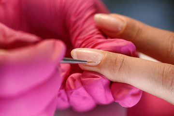 beautician applying Polish nails