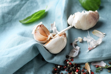 Fresh garlic with spices on fabric