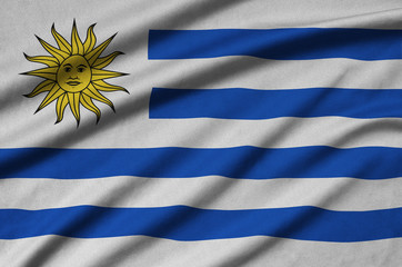 Uruguay flag  is depicted on a sports cloth fabric with many folds. Sport team banner