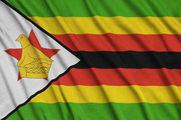 Zimbabwe flag  is depicted on a sports cloth fabric with many folds. Sport team banner