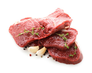 Pieces of raw meat with spices on white background