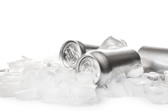 Cans of beer in ice cubes on white background