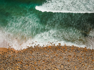 Aerial view of sandy beach with waves perfect spot for surfing. Drone photo 