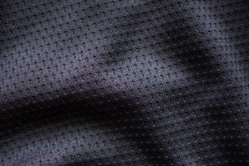 Fototapeta na wymiar Black fabric sport clothing football jersey with air mesh texture background