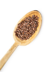 Wooden spoon with linseed or flax seed from lower left isolated on white background