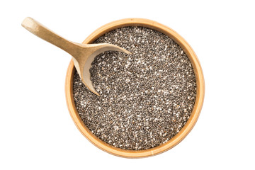 Chia seeds in a wooden bowl with spoon to the left seen from above isolated on white background