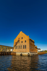 Fototapeta na wymiar Traditional red brick building by the canal in Copenhagen, Denmark