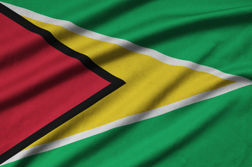 Guyana flag  is depicted on a sports cloth fabric with many folds. Sport team banner