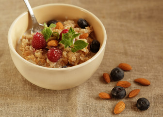 Oatmeal with fresh berries and nuts close up