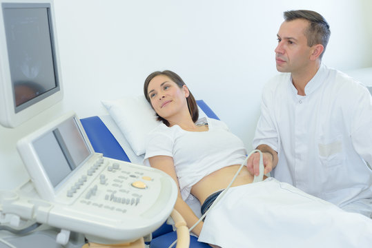 pregnant woman looking at screen during ultrasound