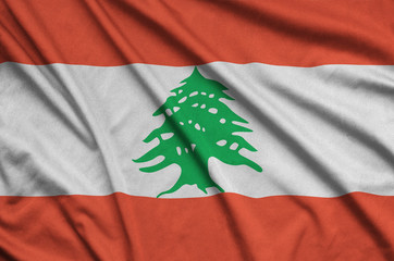 Lebanon flag  is depicted on a sports cloth fabric with many folds. Sport team banner