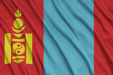 Mongolia flag  is depicted on a sports cloth fabric with many folds. Sport team banner