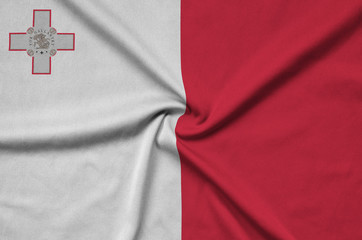 Malta flag  is depicted on a sports cloth fabric with many folds. Sport team banner
