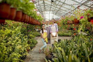 Little girl, young woman and senior woman  in the flower garden