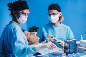 Dentists with a patient during a dental intervention