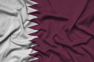 Qatar flag  is depicted on a sports cloth fabric with many folds. Sport team banner