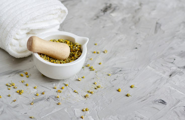 Obraz na płótnie Canvas Dried chamomile flowers, natural ingredients for homemade body, face salt scrub, mask, SPA concept